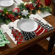 a christmas table setting with plates and napkins