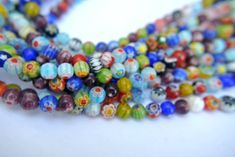 multicolored glass bead necklace on white background