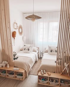 two beds in a room with white walls and wooden slats on the windowsill