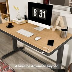 an all in one computer desk with a clock on the monitor and keyboard sitting on it