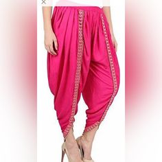 Rayon Fabric Dhoti Pants With Foil Mirror Lace. Elastic Waist Adjustable Till Size 42. Length 37”. Color Options Are Fuchia Pink Festive Ankle-length Pants For Diwali, Bollywood Style Festive Ankle-length Pants, Fitted Bottoms For Diwali Festival, Traditional Harem Pants For Festive Occasions, Traditional Festive Harem Pants, Fitted Bollywood Bottoms For Navratri, Bollywood Style Festive Ankle-length Bottoms, Festive Bollywood Style Harem Pants, Traditional Drape Summer Festive Pants