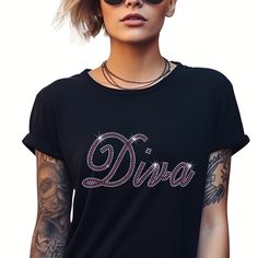 Elevate your style with our Rhinestone Diva T Shirt crafted from premium ringspun cotton for unmatched comfort and durability. Adorned with sparkling rhinestones, this T Shirt exudes wisdom and confidence. Embrace your inner strength while enjoying the softness and quality of our meticulously designed garment.  Size of Design  Width - 9.02 inches Height - 4.05 inches NOTE TO CUSTOMER'S *  All UK and International orders are dispatched tracked and signed. All T Shirts are made from 100% ring spun Rhinestone Cotton Crew Neck T-shirt, Graphic Tee With Rhinestones And Crew Neck, Cotton T-shirt With Rhinestones And Short Sleeves, Cotton T-shirt With Rhinestones Short Sleeve, Cotton Short Sleeve T-shirt With Rhinestones, Black Cotton T-shirt With Rhinestones, Cotton Glitter Print T-shirt, Rhinestone Graphic Tee, Tshirt Crafts