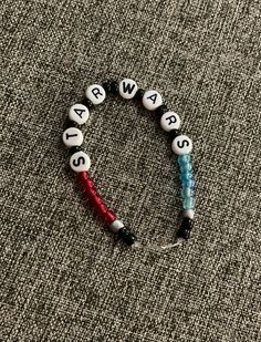 a beaded bracelet with letters and beads on the end is saying, may the 4th be with you