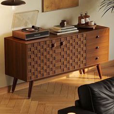 a living room with a couch, table and record player on top of the dresser