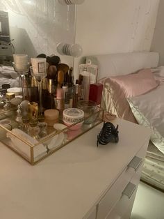 the vanity is full of cosmetics and perfume bottles