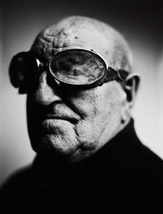 an old man with glasses looking at the camera