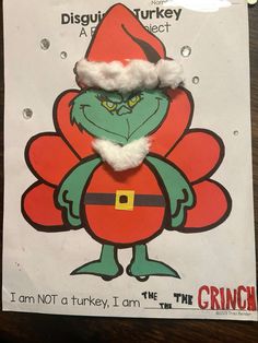 the grinch is wearing a santa hat and standing in front of a sign that says, i am not a turkey