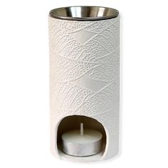 a white toilet paper roll holder with a candle in the center and a silver lid