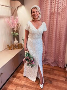 a woman in a white dress holding a bouquet