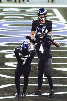 two football players are standing on the field