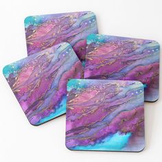 four coasters with purple and blue marble designs on the top one has gold dots