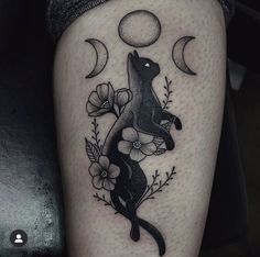 a black cat sitting on its hind legs with flowers and moon in the sky above it