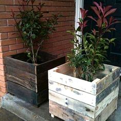 two wooden planters sitting on the side of a building