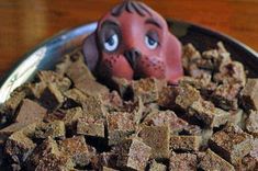 a bowl full of dog treats with a toy head sticking out of it