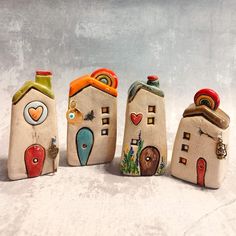 three ceramic houses are sitting in the snow