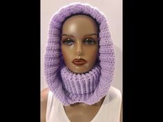 a mannequin head wearing a purple knitted scarf