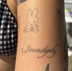 a person with tattoos on their arms and legs, has the words serendibity written in cursive writing