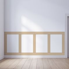 an empty room with white walls and wooden floors