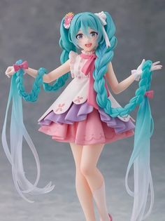 a figurine that is wearing a dress and holding two long blue braids