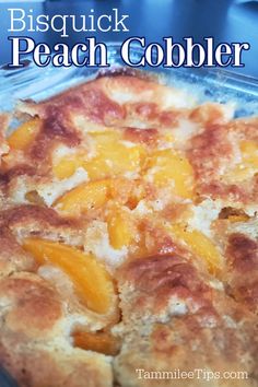 a close up of a casserole dish with peach cobbler topping on it