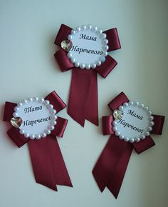 three ribbons with name tags attached to them