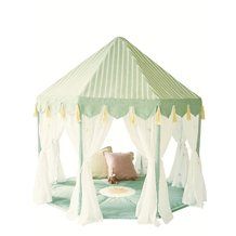 a green and white tent with curtains on it's sides, sitting next to a pillow