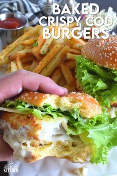 a close up of a person holding a sandwich and french fries with the words baked crispy god burgers