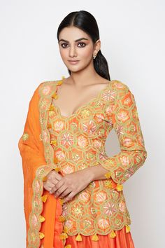 Orange short kurta with embroidered floral motifs. Comes with lehenga and dupatta.
Component: 3
Embroidery
Neckine: V neck
Sleeve Length: Three fourth
Fabric: Silk
Color: Orange
Zari trim detail on lehenga hem
Embroidered floral motifs on dupatta
Tassel detail on dupatta border and kurta hem - Aza Fashions Orange Dupatta With Intricate Embroidery For Reception, Festive Orange Lehenga With Intricate Embroidery, Orange Embroidered Sets For Reception, Semi-stitched Orange Choli With Intricate Embroidery, Orange Anarkali Sets With Intricate Embroidery, Orange Sharara With Intricate Embroidery For Reception, Orange Semi-stitched Choli With Intricate Embroidery, Orange Saree Set With Intricate Embroidery, Orange Intricate Embroidered Sharara For Reception