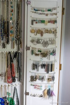 a white closet filled with lots of jewelry