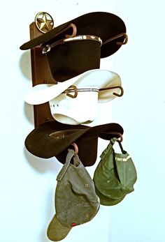 several hats and purses hanging on a wall