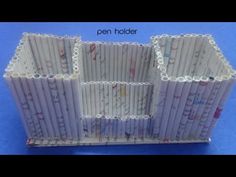 an open holder made out of white paper with writing on it and the words pen holder