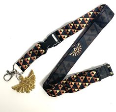 PRICES MAY VARY. Officialy Licensed Detatchable Clasp makes this lanyard Perfect for keychain, cell phone, camera, MP3, ID Badge etc.... Double Sided Print - Zelda Hyrule Emblem with Black Background / Tri-Force EmblemPattern with Black Background Gold Metal Hyrule Charm. Measures 1.75" x 1.25" The Legend of Zelda Hyrule Crest Double Sided Lanyard with metal clasp to be used as a keychain, ID Badge Holder, and Charm. Show off your Zelda gamer pride with this high quality lanyard - whether your a Background Gold, Nintendo Game, Phone Camera, Id Badge Holders, The Legend Of Zelda, Badge Holder, Id Badge, Badge Holders, Legend Of Zelda