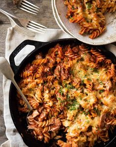 a skillet filled with pasta and meat