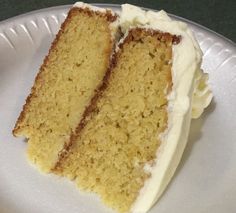 two slices of cake sitting on top of a paper plate with white frosting and icing