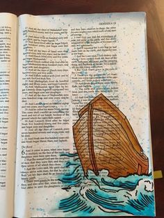 an open book with a drawing of a boat in the water on top of it