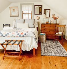 a bedroom with wooden floors and white walls