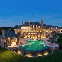 a large mansion with a pool in the front yard