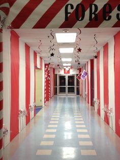 the hallway is decorated with red and white striped walls, stars hanging from the ceiling