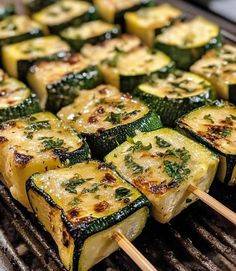 grilled vegetables on skewers being cooked on an outdoor grill with chopsticks