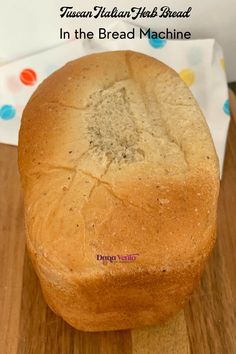 a loaf of bread sitting on top of a wooden cutting board