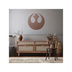 a living room with a star wars logo on the wall and two chairs in front of it