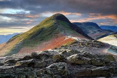 the mountain is covered in rocks and grass