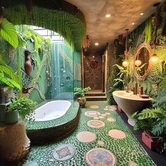 a bathroom decorated in green and white with lots of plants on the walls, along with an oval bathtub