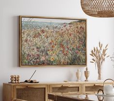 a painting hanging on the wall above a dining room table