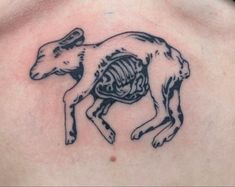 a goat skeleton tattoo on the back of a man's chest, with ribs exposed