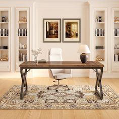 an office with white chairs and a wooden table in front of bookshelves filled with books