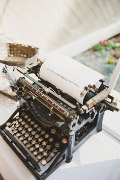 an old fashioned typewriter sitting on top of a table