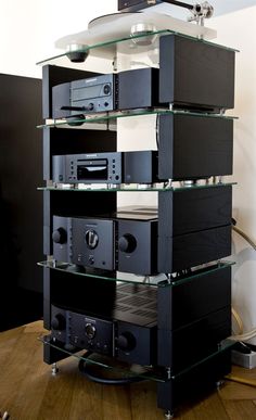 a stack of stereo equipment sitting on top of a wooden floor