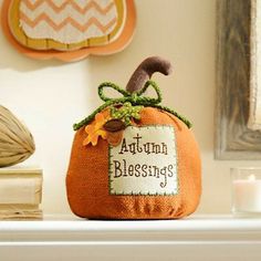 an orange pumpkin sitting on top of a mantle