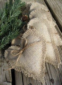 a piece of burlock and pine needles on a wooden table with wood planks